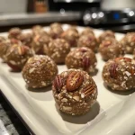 Close-up view of Chai Spiced Energy Bites arranged on a white surface.