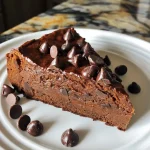 Close-up view of a moist slice of Healthy Sweet Potato Chocolate Cake with chocolate chips on top.