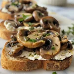 Close-up of Lemony Mushroom Mascarpone Toast topped with fresh herbs.