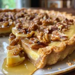 Close-up view of a Maple Walnut Tart with crust and topping visible.