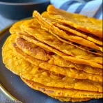Close-up view of a golden-brown sweet potato tortilla, showcasing its texture.