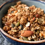 Close-up view of a bowl filled with colorful protein granola.