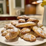 Close-up image of Witch Finger Cookies shaped like fingers with almond nails.
